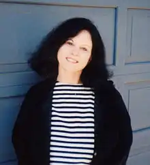 Maxine Chernoff in front of her house