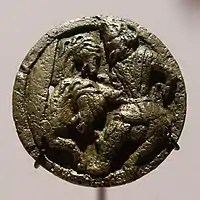 Medallion with man in Central Asian costume attending two horses, Takht-i Sangin, 2nd century BC-2nd century AD. The costume is said to be "Scythian".