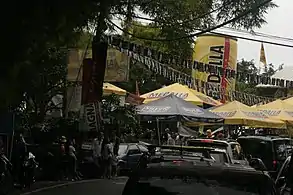 Street party and Medalla Beer umbrellas