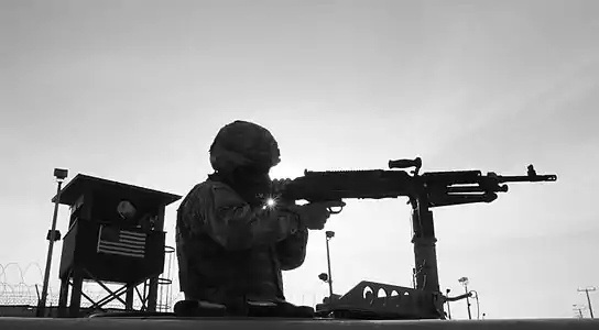 A member of the Puerto Rico Army National Guard, Bravo Company, 1/296th Infantry Regiment patrols outside Camp Delta, December 8, 2010. The regiment is supporting the Joint Task Force Guantanamo mission.