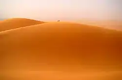 Two people atop one of the main dunes