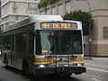 A Metro Local bus with the old "yellow jacket" paint scheme.