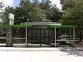 MetroRapid North-South Station C featuring modern design, Ticket Vending Machine, bike rack and solar lighting.