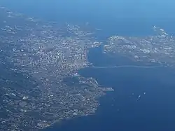 Aerial view of Metro Cebu in 2023. To the left is Cebu City, to the right is Mactan.