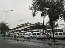 Picture of multiple rooftops whose building is covered by several buses