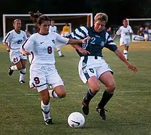 Image 6Mia Hamm (left) battles with German defender Kerstin Stegemann (from Women's association football)