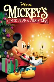 Mickey Mouse is standing at the left side of the image is holding a candle holder with a brightly burning candle, positioned on the right side of the image, with both of his hands. Mickey is wearing his traditional red shorts with white buttons and yellow shoes and as usual, is happily smiling. In the background on the left side of the picture stands a decorated Christmas tree with colorfully wrapped gifts lying under it. The video cover includes the film and company's title.