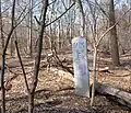 Milepost 6 located in Van Cortlandt Park; former railbed on left