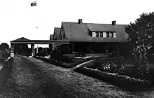 black and white 1912 image of Covenhoven mansion, surrounded by trees and driveway