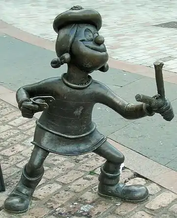 Image 37Statue of Minnie the Minx, a character from The Beano. Launched in 1938, the comic is known for its anarchic humour, with Dennis the Menace appearing on the cover. (from Children's literature)