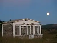 Large white concrete tomb in a grassy field in Madagascar