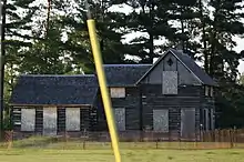 Historic Dinesen-Motzfeldt-Hettinger Log House before restoration, listed on the National Register of Historic Places