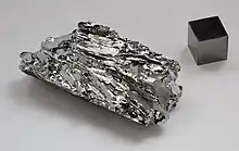 Molybdenum crystals and a 1 cm3 molybdenum cube for comparison