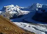 A view of Gorner Glacier in front, the Monte Rosa massif in the middle, and the major tributary of the Gorner Glacier, the Border Glacier (German: Grenzgletscher) to its right and the impressive Liskamm on the Swiss-Italian border, as viewed from Gornergrat (September 2007).