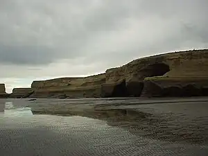 Sandstone cliffs over the park's beach