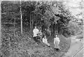 Members of the Montgomerie family under a flowering Laburnum tree within the Dalmore House gardens