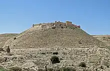 A ruined castle built of stones on a hill