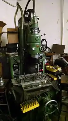 A manual milling machine with a crank controlled X-Y table.