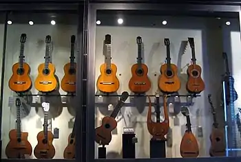 Three Lacôte guitars (bottom row, 2nd, 3rd, and 4th guitars)