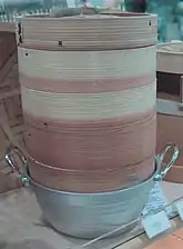 Stacked bamboo steamers on top of a pot