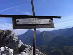 Small metal cross with the inscription "11.9.1977 - To the Néron, debonair, but formidable" and initials.