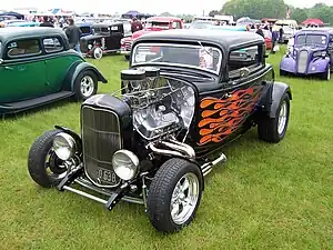 Hiboy Deuce, with chopped top, drag headers, and tunnel ram intake manifold (with dual quad carburetors), and aftermarket dropped axle and disc brakes, based on 1932 Model 18 or B three-window coupe