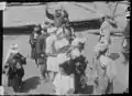 1929 approx. Kunisht (Rumbur Sheikhandeh), Rumbur Valley, Chitral, NWFP, Pakistan Photograph (nr. 1 of 3) reproduced from Georg Morgenstierne's unique film documentary from Chitral. Overview picture from the Kati dance. The male Kati dancers are dressed as usual for this occasion in their best clothes, silk costumes (talar) and turbans. The dance on the ground beside the dancing floor is called Zhige.