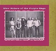 A black and white photo of the band lined up in front of a wall. Left to right: Dave Torbert, John Dawson, Spencer Dryden, David Nelson, Buddy Cage.