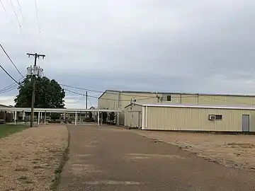 West of the main school building, the forward most building in the image is the field house, with the gym and cafeteria behind, respectively