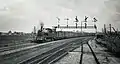 NS 6108 with an express train Enschede-Amsterdam near the signal gantry near Bussum. (Between 1925 and 1935)