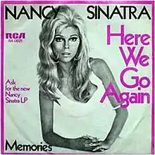 Black and white cover art photo of Nancy Sinatra on one elbow in a white dress. The border is purple as is some of the captioning. Caption says Nancy Sinatra in black. Side captions detail the record label and the song name in purple. The bottom caption has the B-side song name, "Memories".