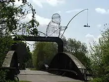 Naburn railway bridge near York, showing "The Fisher of Dreams" iron cage sculpture