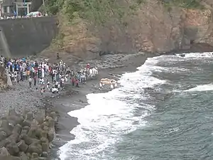 An o-waraji is carried into the sea at a waraji festival, Nakiri-jinja, 2006