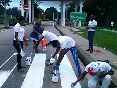 KNUST students repainting the zebra crossings in their school, Kumasi