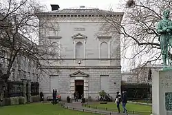 Façade of the museum with trees in the foreground.