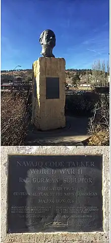 Navajo Code Talker is a Bronze bust sculpture created by famed Navajo Artist R.C. Gorman. Gorman used his father, Carl's likeness for this sculpture. Carl was a Navajo Code Talker in WWII. The face is that of an elderly Navajo man looking up and our in a proud manner. It sits on an 8ft marble base on the NAU campus in Flagstaff Arizona. Bright blue skies surround the bust with the mountains visible in the distance.