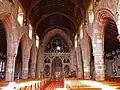 The nave, showing the wrought-iron screen by William Butterfield