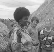 Ndeutala Hishongwa, a Namibian writer and activist, at CERES in 1988 in front of African huts.