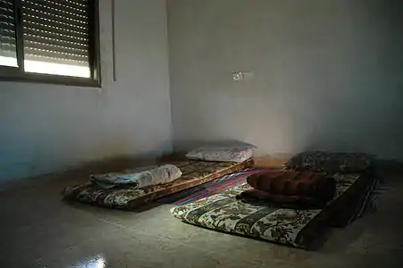 Beds in the West Bank, with brightly-patterned cloth