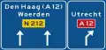 K11: Lane instructions on a non-motorway highway. Panel showing intermediary destinations, road numbers and directions to a motorway