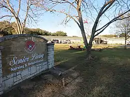 Photo shows SPJST Senior Living sign in front of building.