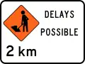 (TW-1B.2.2) Road workers ahead in 2 kilometres, delays possible