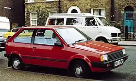 A small three-door car with a two-box body style with steel wheels and door mirrors