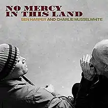 Ben Harper playing a guitar and Charlie Musselwhite playing a harmonica