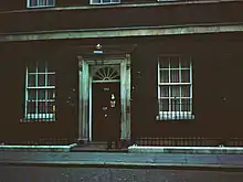 A dim shot of the door of 10 Downing Street