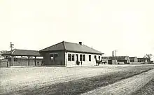 A suburban railway station with a one-story brick building