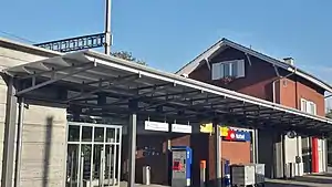 Two-story building with gable roof and single-story wing