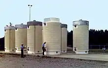 Image 11Dry cask storage vessels storing spent nuclear fuel assemblies (from Nuclear power)