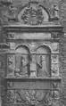 A mural monument in late renaissance style showing a man in armour and a woman kneeling in prayer