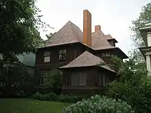 Exterior view of the Geoarge W. Smith house from right front corner to demonstrate a similar porch design and main house massing to the Hills House.  The Smith house has the same roof, but its eaves are shallower and flared ends are less pronounced.